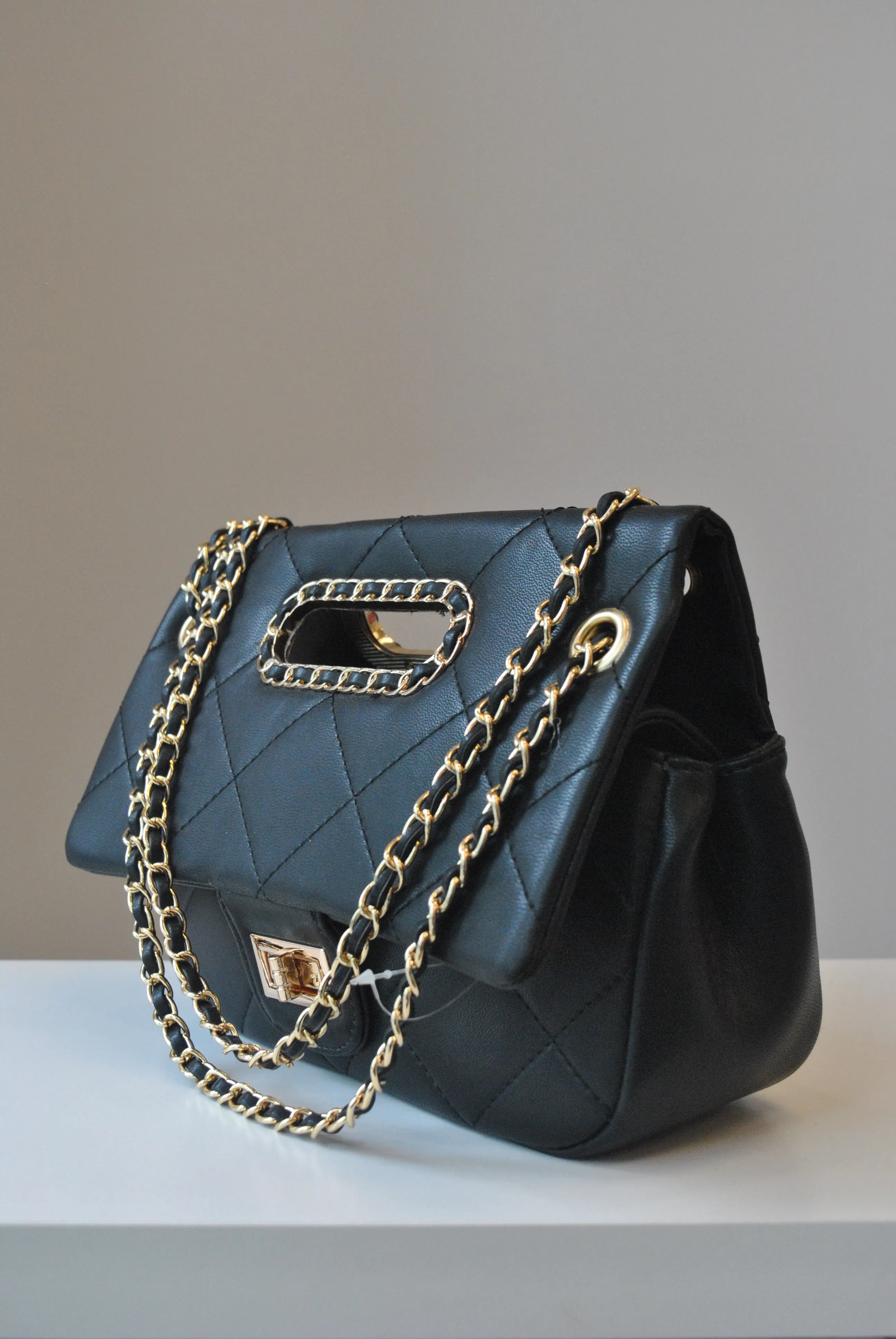 BLACK GUILTED HANDBAG WITH CUTOFF  HANDLE AND GOLD CHAIN