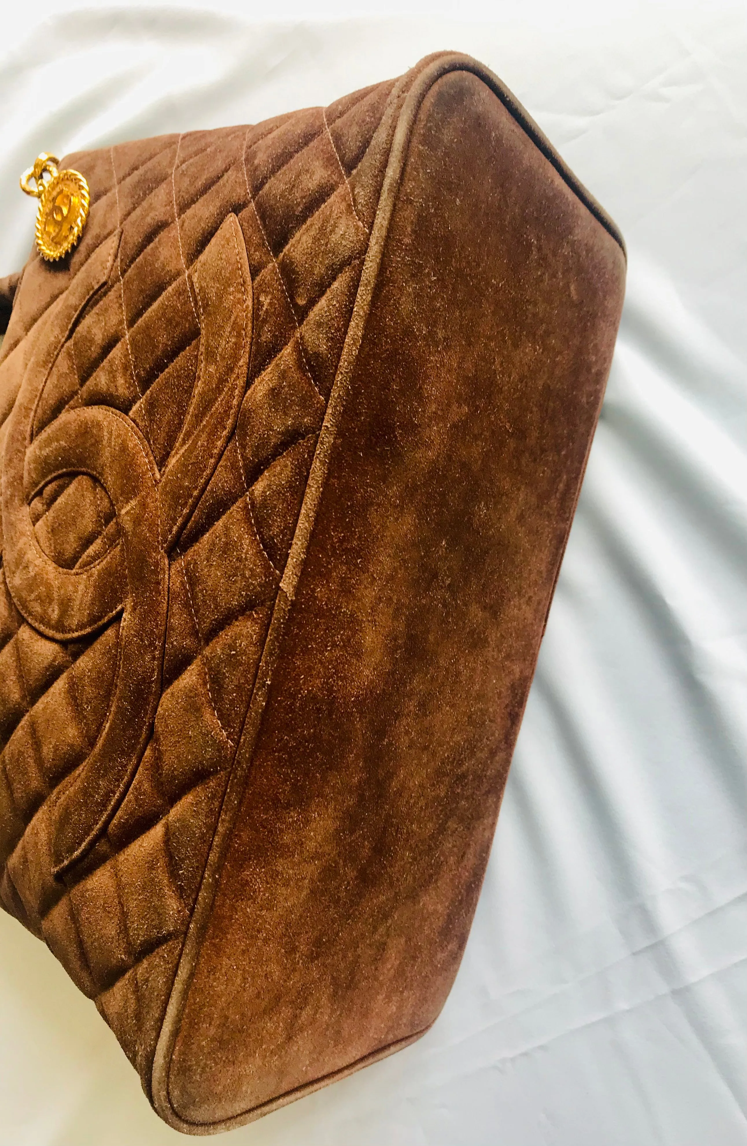 Vintage CHANEL brown suede classic tote bag with large CC mark and golden CC medal charm to the zipper. Classic purse for daily use.