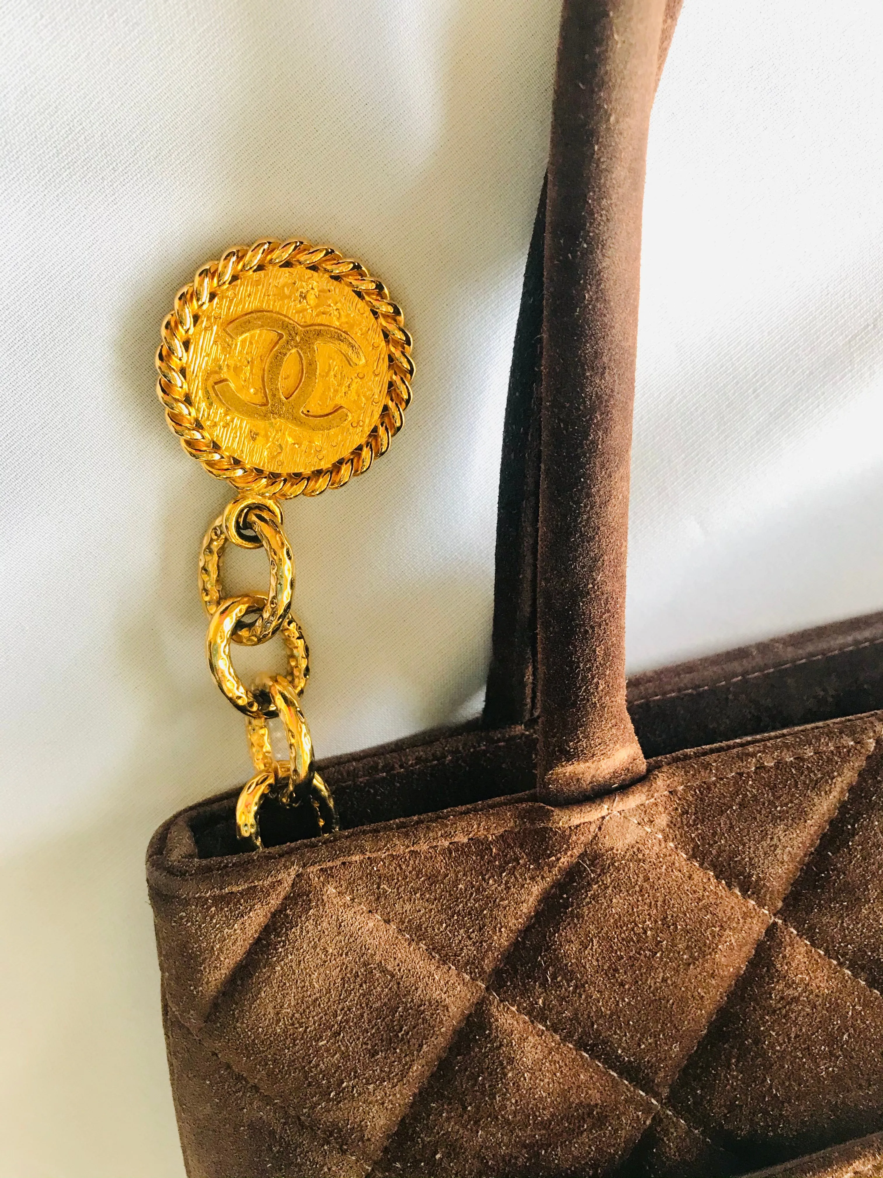 Vintage CHANEL brown suede classic tote bag with large CC mark and golden CC medal charm to the zipper. Classic purse for daily use.