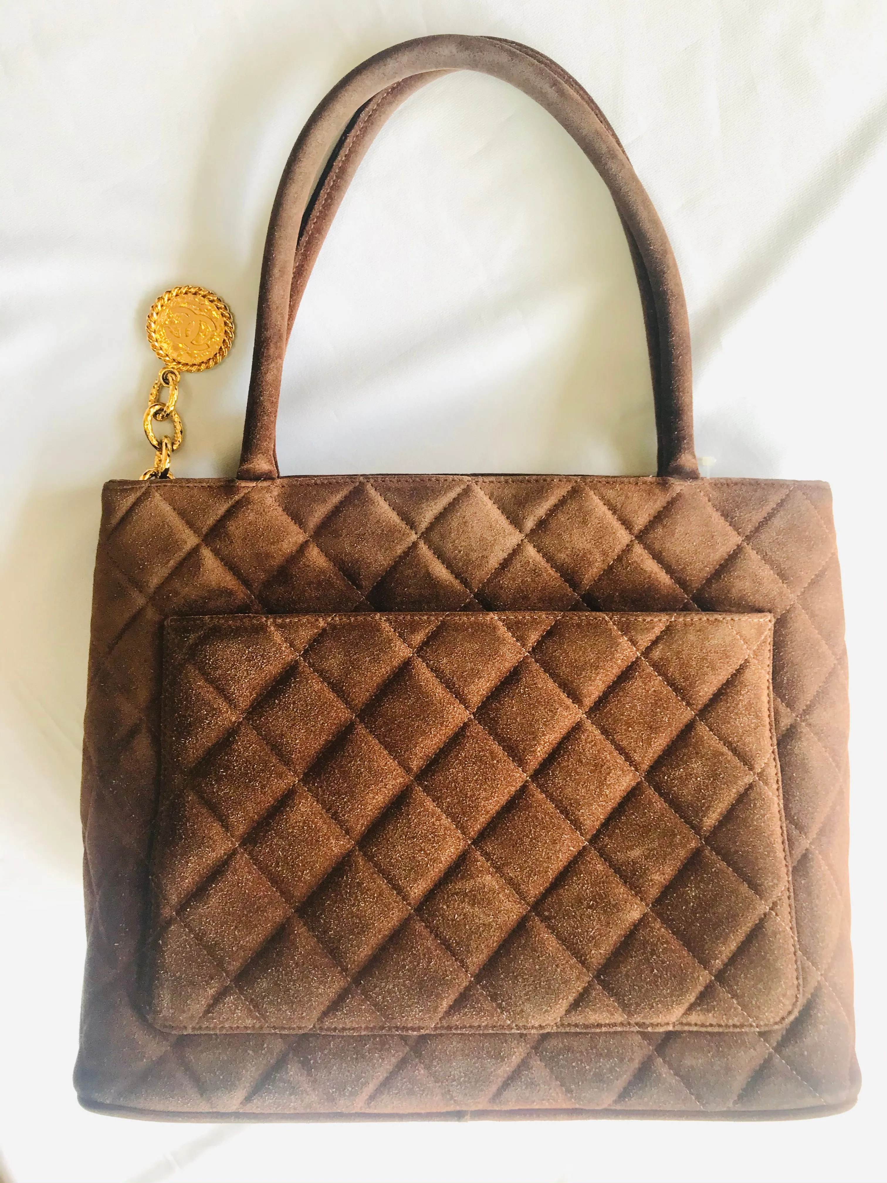 Vintage CHANEL brown suede classic tote bag with large CC mark and golden CC medal charm to the zipper. Classic purse for daily use.
